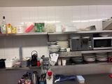 a kitchen with a lot of dishes on the counter