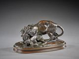 bronze statue of a lion attacking a boar on a wooden base