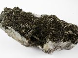 the rock is covered with moss and dirt on a white surface