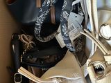 a person holding a purse in a box full of purses
