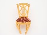 a miniature chair made out of wood with a red seat