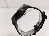 a close up of a watch on a clear plastic stand on a white surface