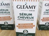 three bottles of glamy serum on a wooden table
