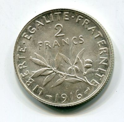 a silver coin with a picture of a flower on it