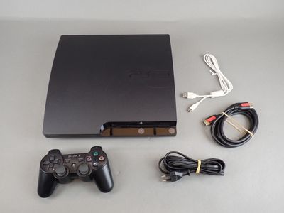 a video game system sitting on a table next to a charger
