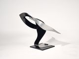 a black and white sculpture of a bird on a stand
