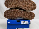 the soles of a pair of shoes are stacked on top of each other