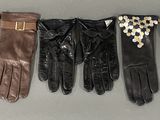 four pairs of leather gloves with gold buckles on them