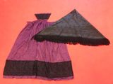 two pieces of purple and black clothing on a pink surface