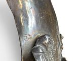 a close up of a metal object with a bird on it