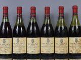 six bottles of wine are lined up in a row on a table