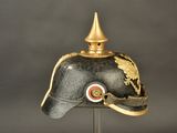 a black helmet with a gold decoration on it