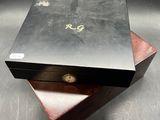 an image of a wooden box with a metal lid on a metal surface