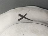 a white hat with a black cross on the side of it