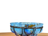 a blue bowl sitting on top of a wooden table