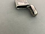 a small silver lighter sitting on top of a table
