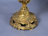 a gold plate with a bird on it on a table