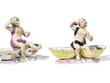pair of porcelain figurines of a boy and a girl in a bowl
