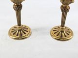 pair of antique brass candlesticks on a white background