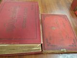 two old books sitting on the floor next to each other