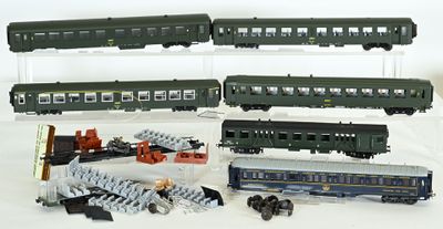 several toy trains are lined up on a white surface
