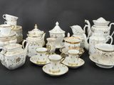 a lot of white and gold tea and coffee cups and saucers