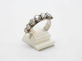a close up of a diamond ring on a white surface