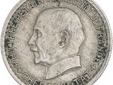 a close up of a silver coin with a man ' s face on it