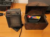 an old radio and a small box on a desk