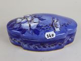 a blue box with flowers on it sitting on a table