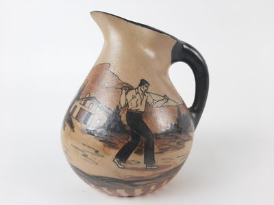 a brown and black vase with a picture of a man on it