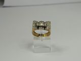 a close up of a gold ring with a bow on top of it