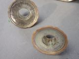 two pieces of metal that are sitting on a table