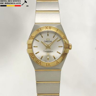 an image of a gold and silver watch with roman numerals