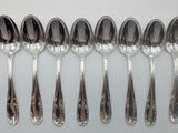 many spoons that are lined up together on the table