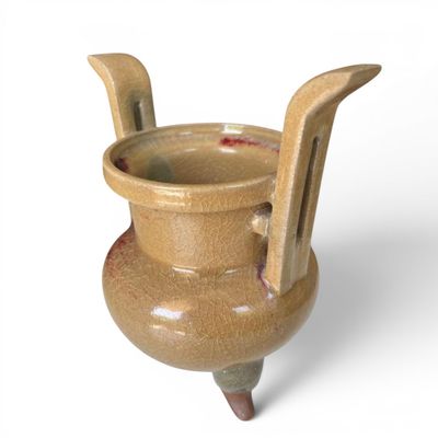 a brown vase with a handle on a white background