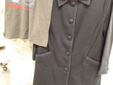 a coat and shirt on a rack in a store