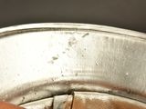 a person holding a metal pan with food inside of it