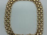 a gold chain bracelet with two clasps on a white background