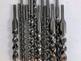 a bunch of drill bits sitting on top of each other