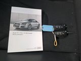 a picture of a car key and a book on a car seat