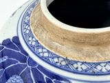 a blue and white vase sitting on a white surface