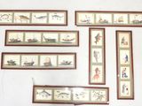 many framed pictures on the wall of a room