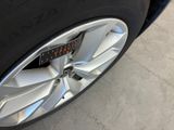 a close up of a car tire with a clock on it