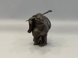 figurine of a man with a stick in his hand on a white surface