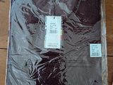 a shirt that is wrapped in plastic on a wooden floor