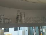 a glass shelf with a bunch of glasses on top of it