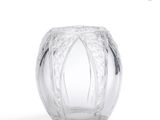 a glass vase that is sitting on a white surface