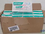 a cardboard box full of toothbrushes on a table