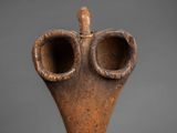 a close up of a vase with a bird on top of it